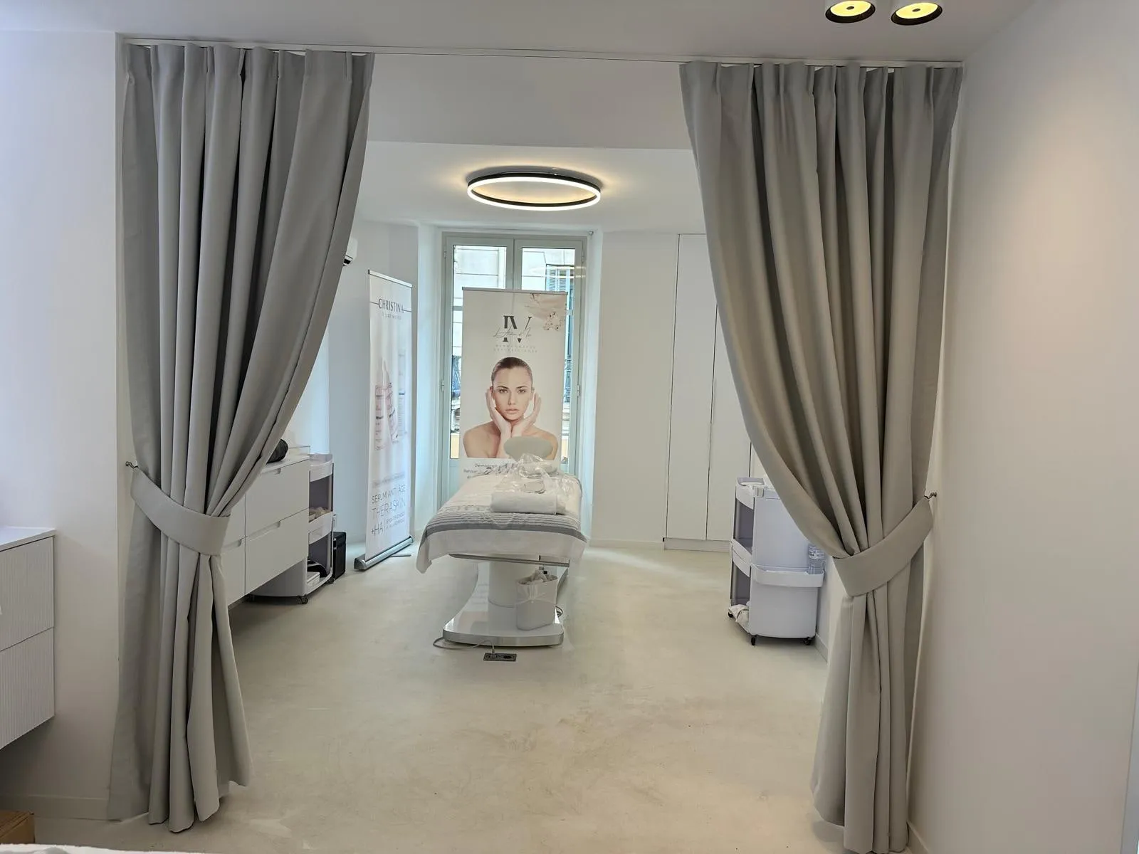 Christina Cannes — arched niches and lit oval mirrors along the salon
