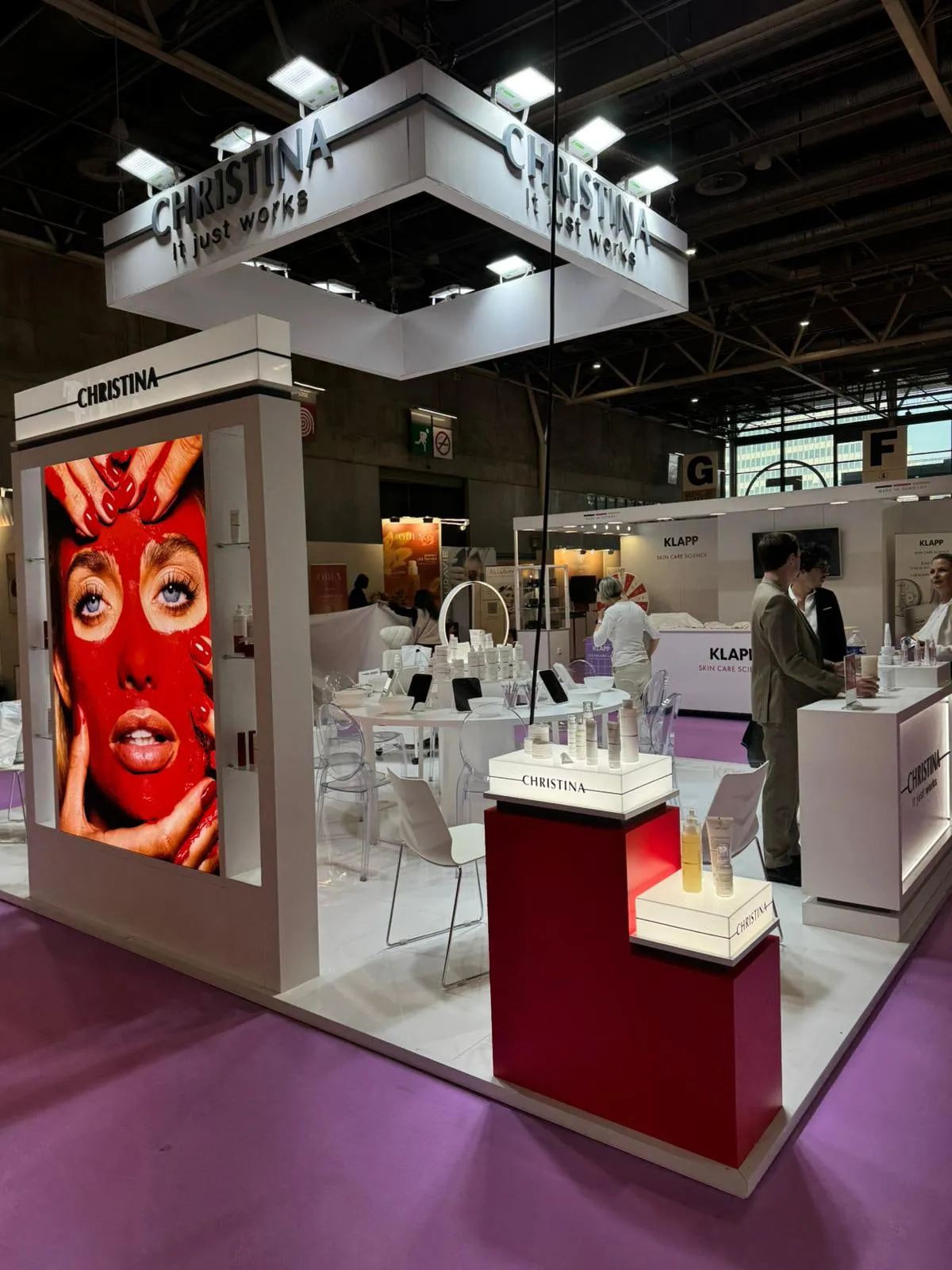 Paris 2026 — the stand with its suspended lighting rig and campaign wall