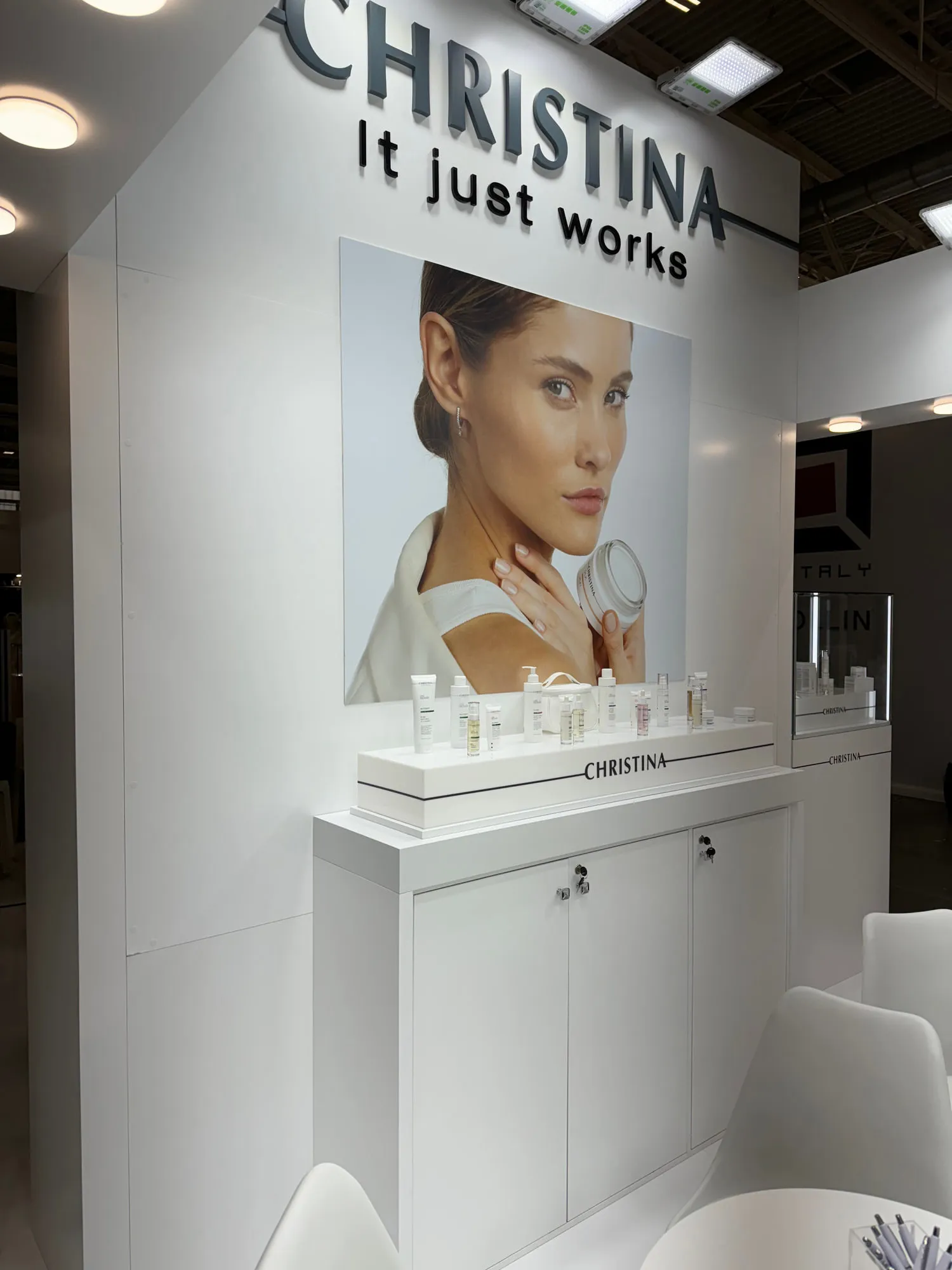 Bologna 2024 — white stand with glass display cases