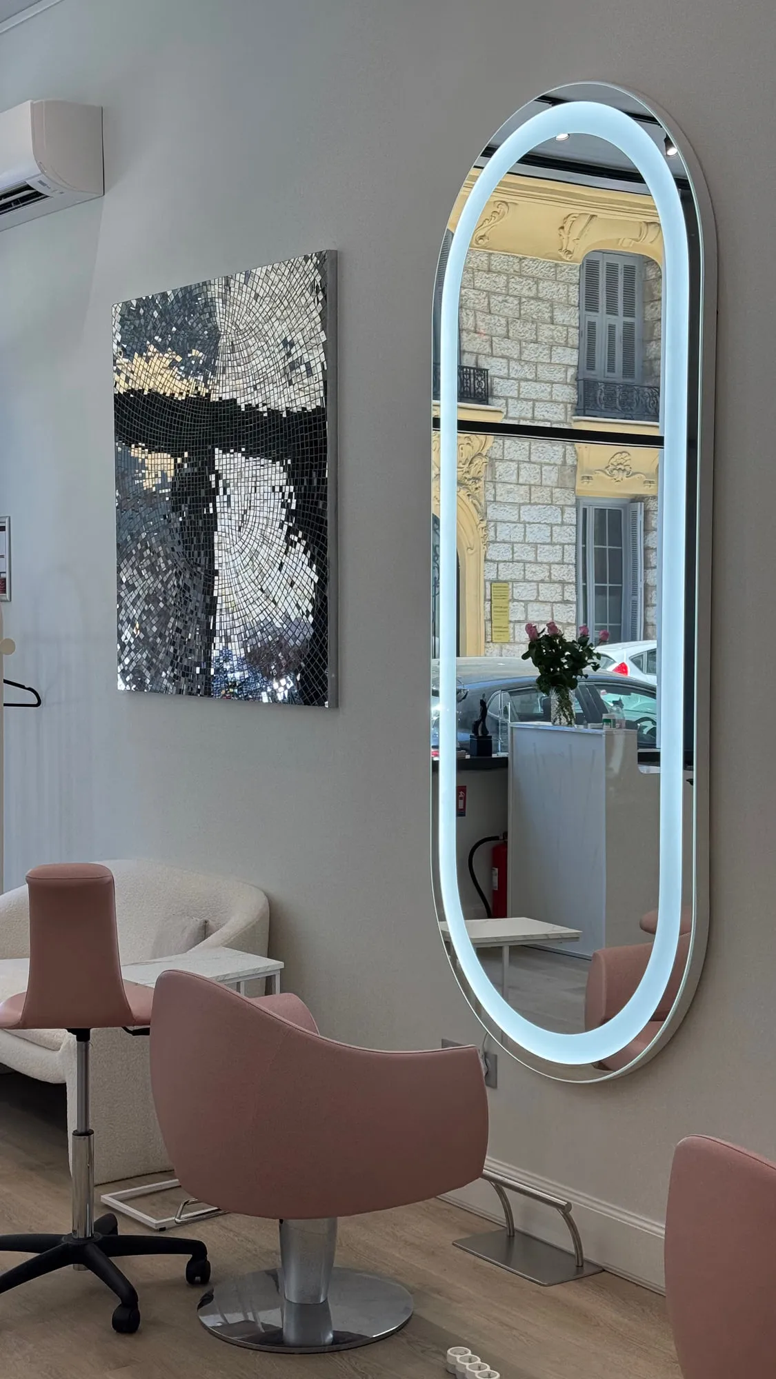 Wow Hair — oval backlit mirrors and dusty-rose chairs along the oak floor