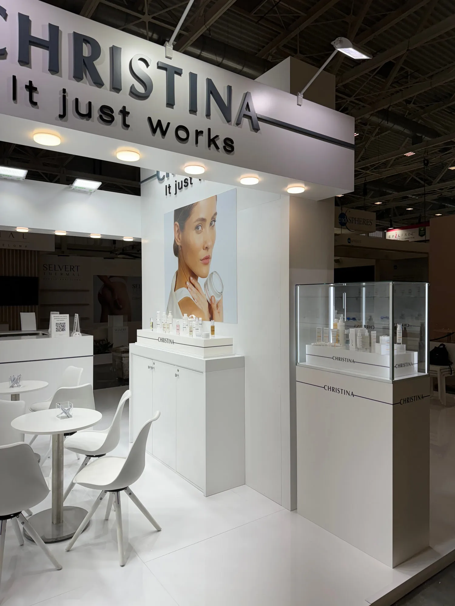 Bologna 2024 — white stand with glass display cases