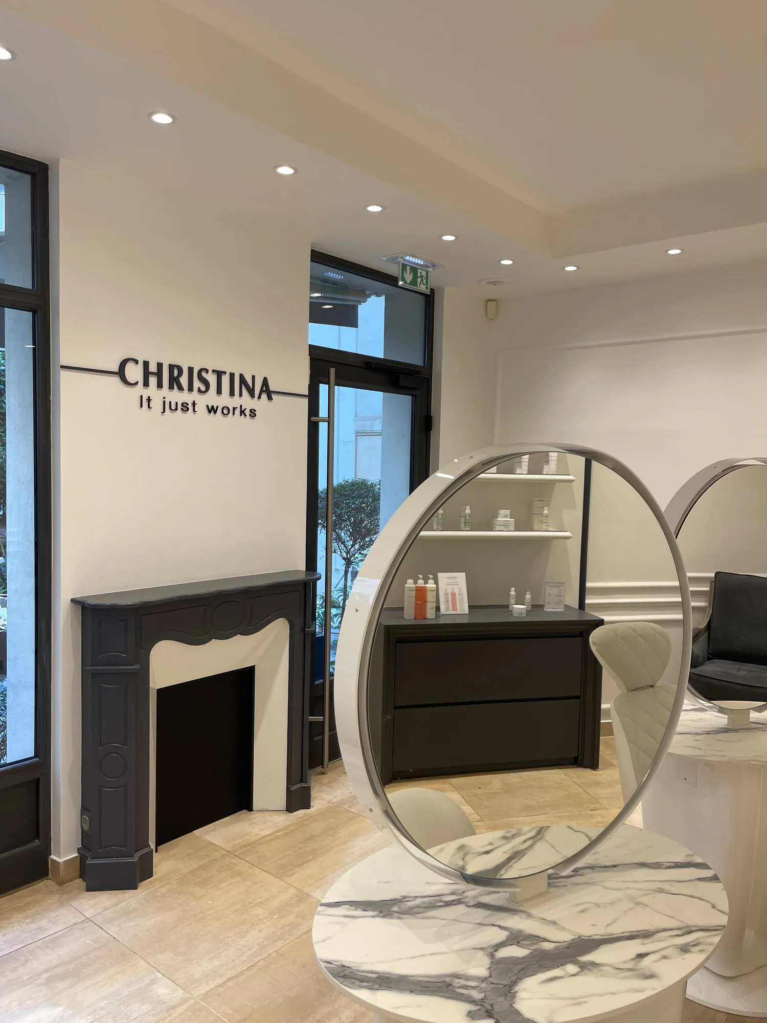 Christina Paris — round mirrors and pedestal stations against exposed Paris limestone