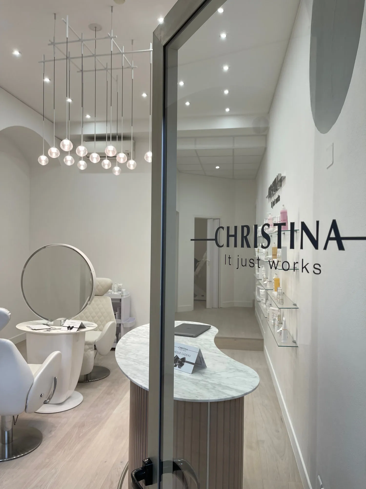 Christina Monaco — arched backlit mirrors above the stations, curved timber reception