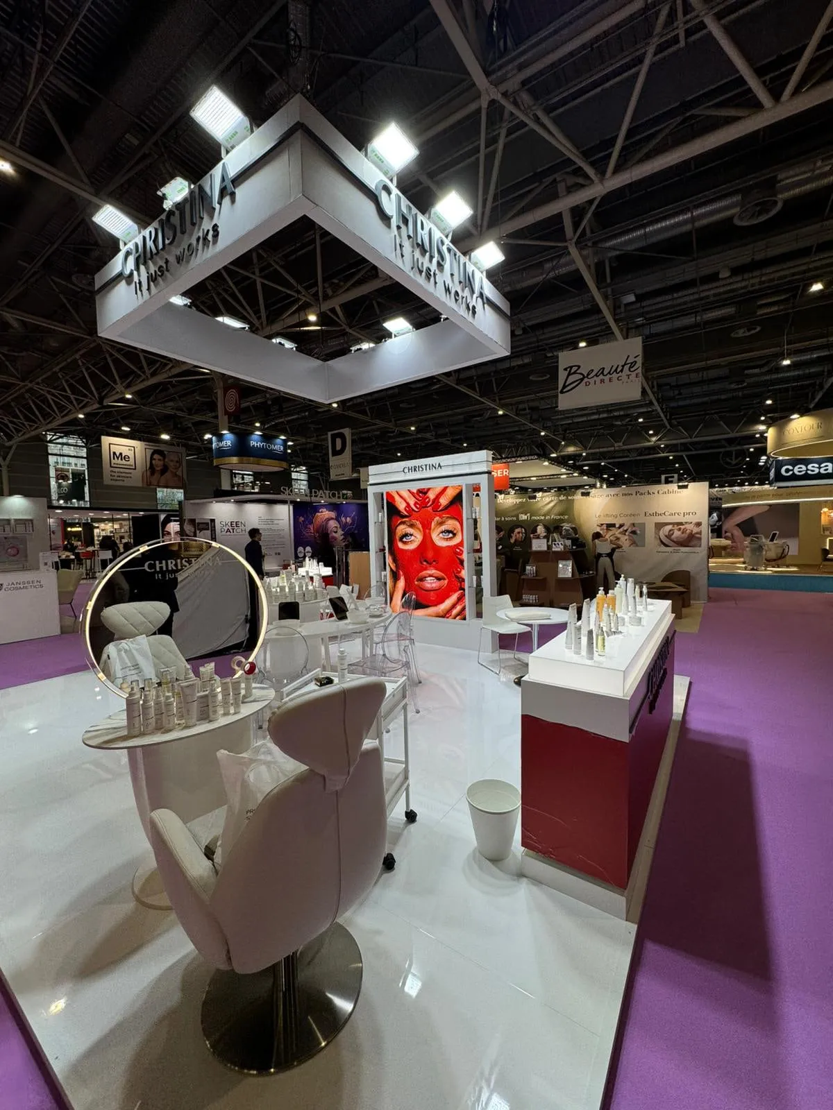 Paris 2026 — the stand with its suspended lighting rig and campaign wall