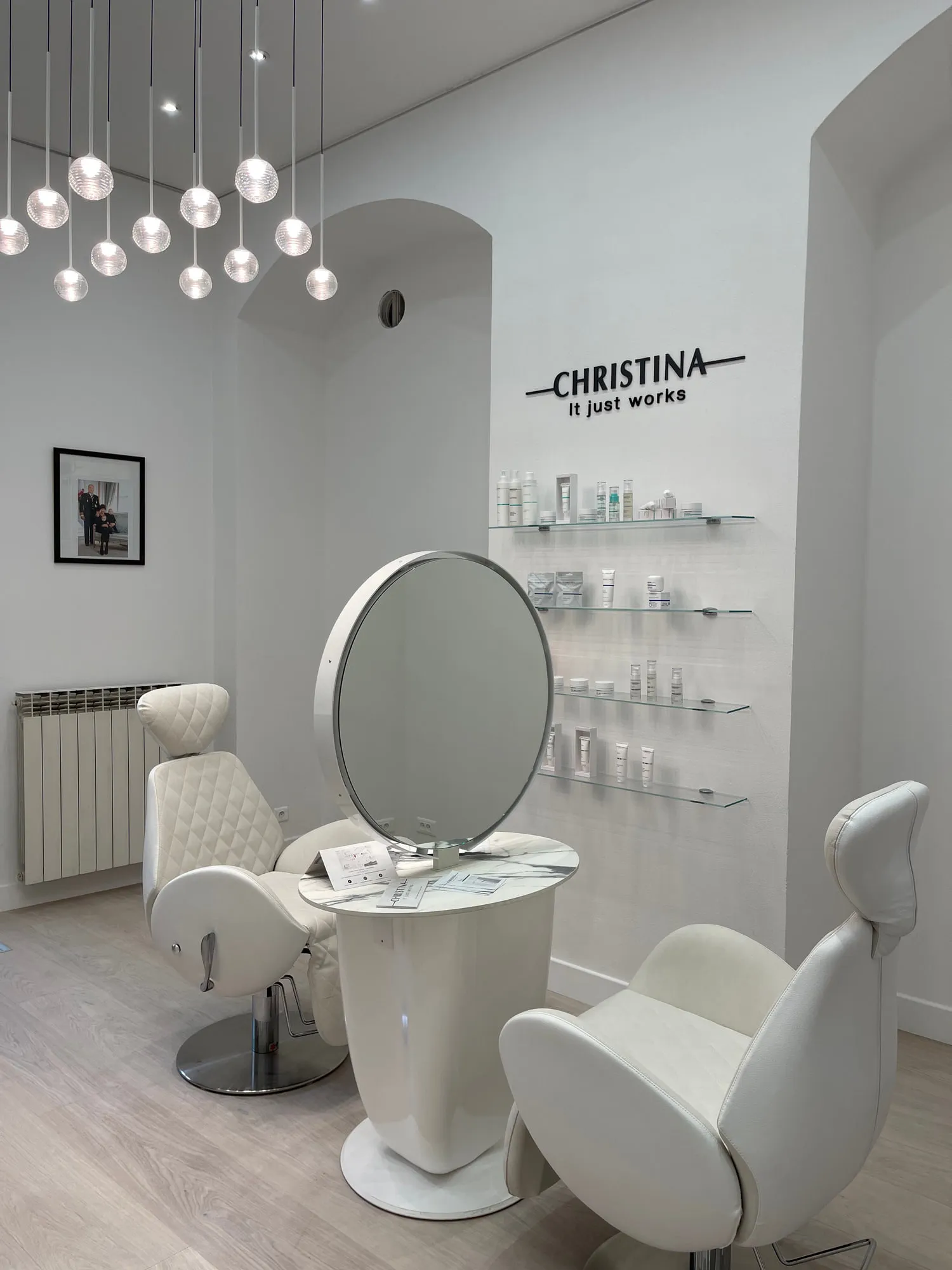 Christina Monaco — arched backlit mirrors above the stations, curved timber reception