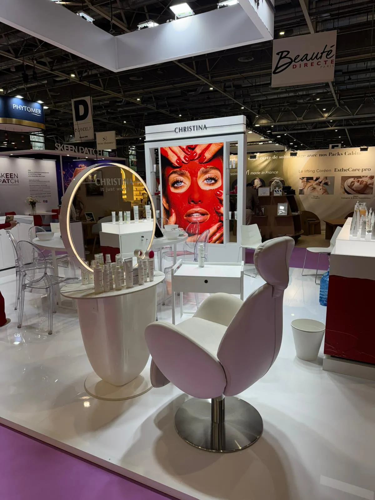 Paris 2026 — the stand with its suspended lighting rig and campaign wall