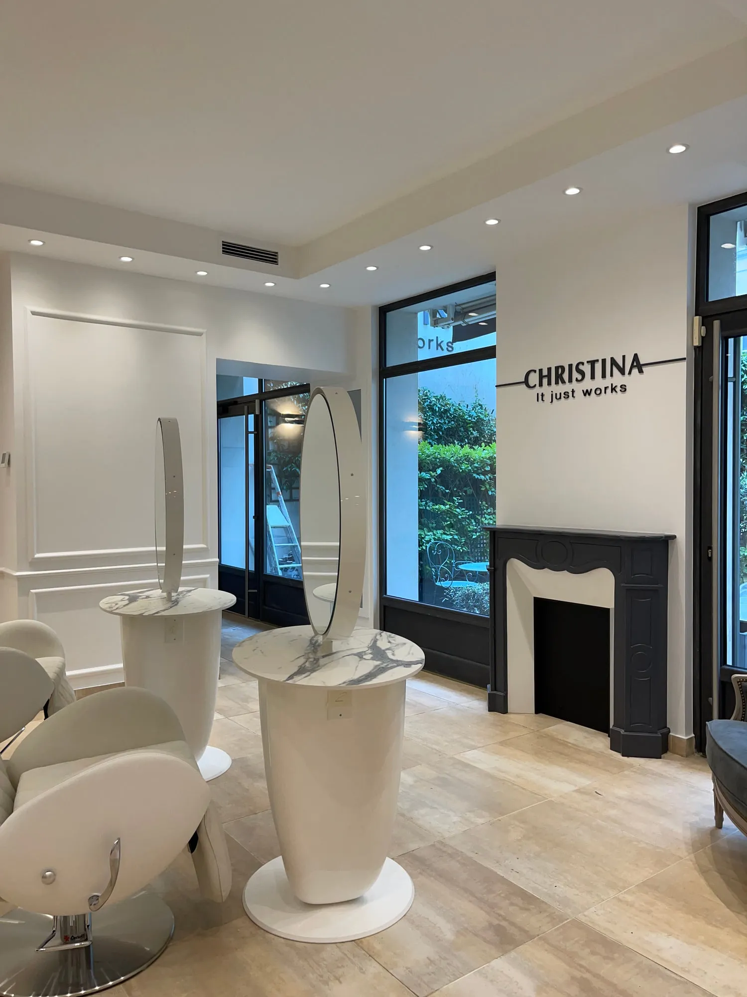 Christina Paris — round mirrors and pedestal stations against exposed Paris limestone