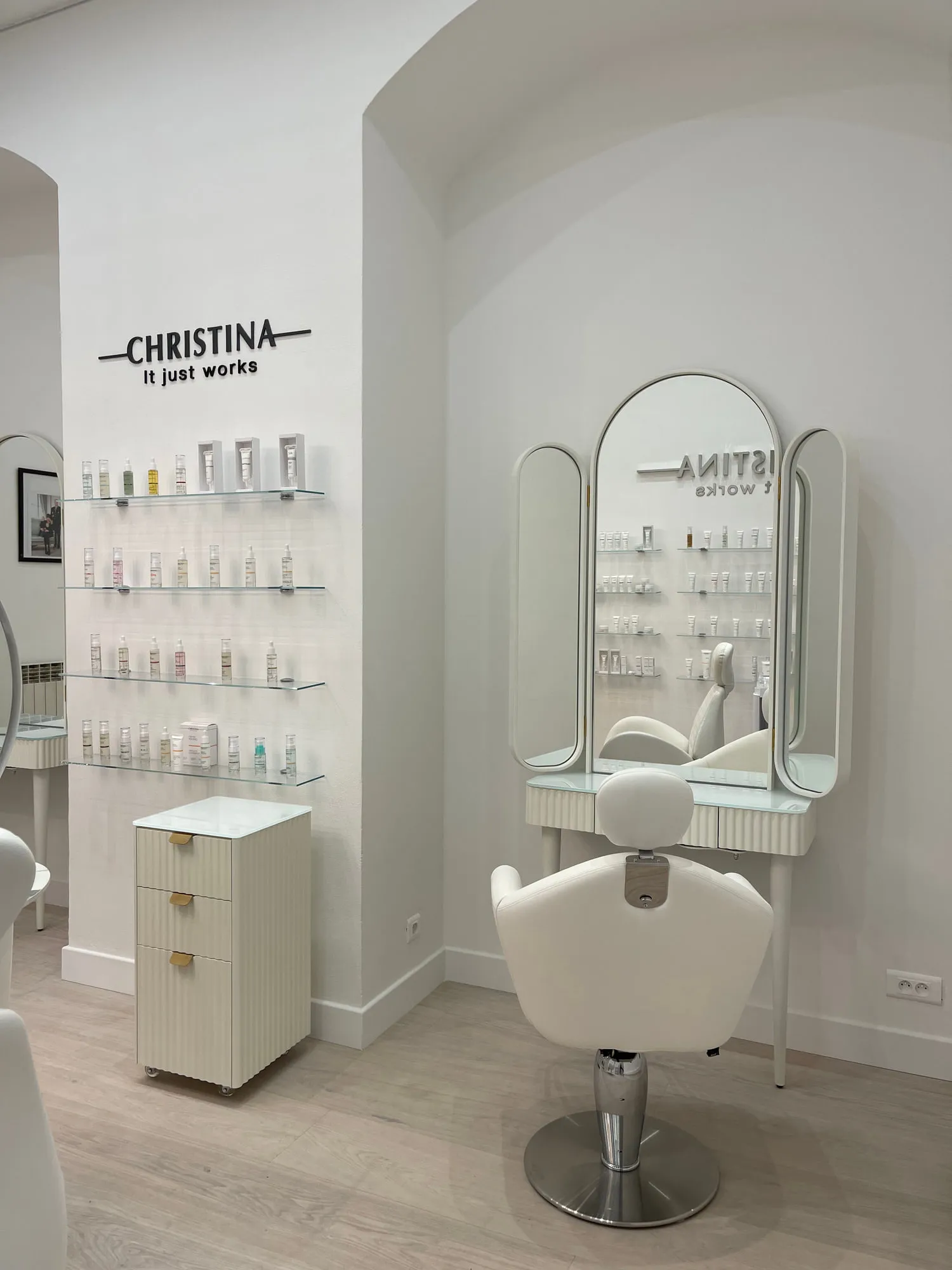 Christina Monaco — arched backlit mirrors above the stations, curved timber reception