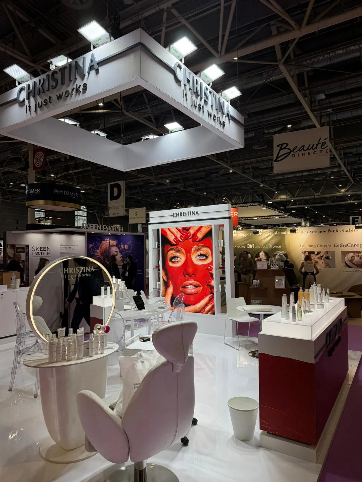 Paris 2026 — the stand with its suspended lighting rig and campaign wall
