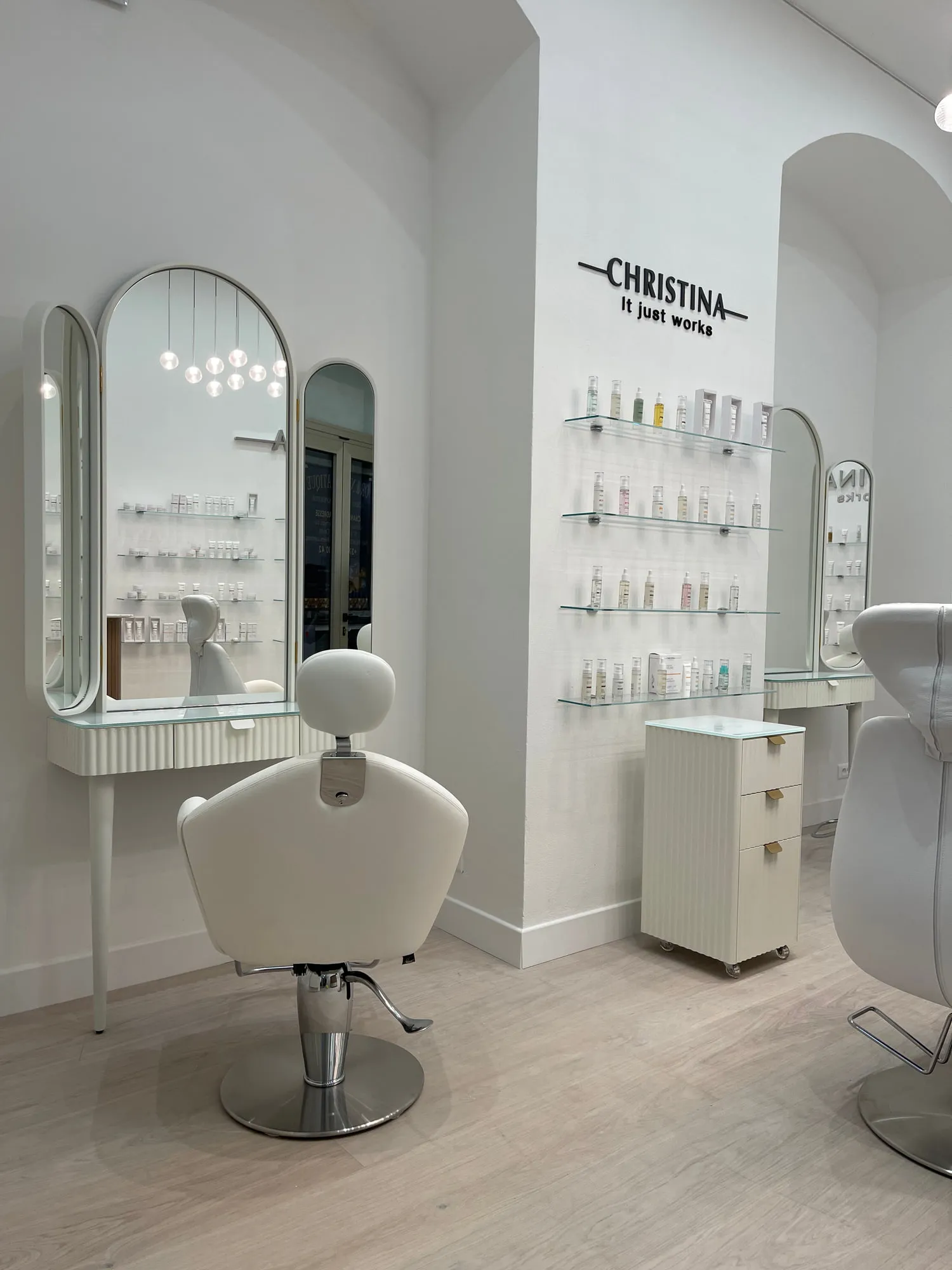Christina Monaco — arched backlit mirrors above the stations, curved timber reception