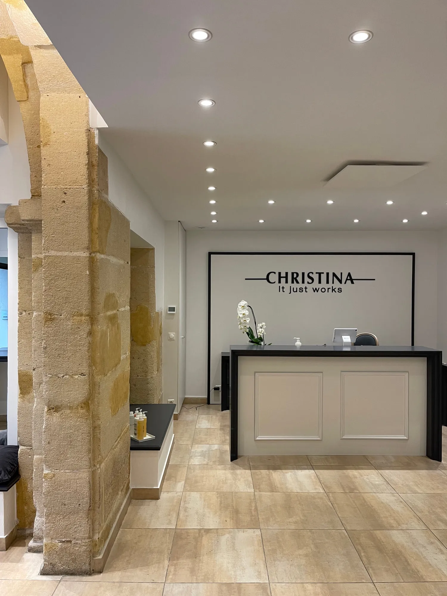 Christina Paris — round mirrors and pedestal stations against exposed Paris limestone