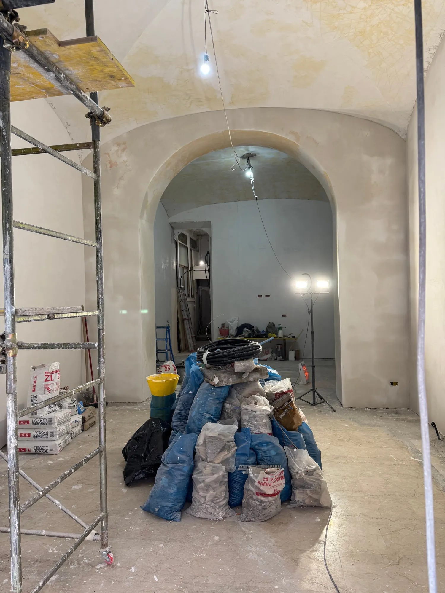 Before — The rear vault, from stripped plaster to the finished treatment bay