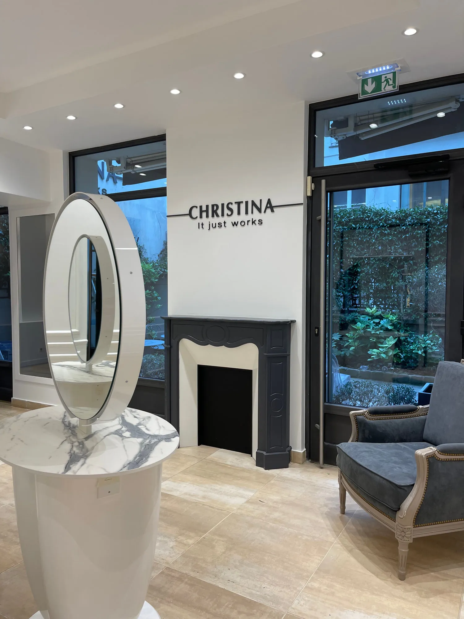 Christina Paris — round mirrors and pedestal stations against exposed Paris limestone