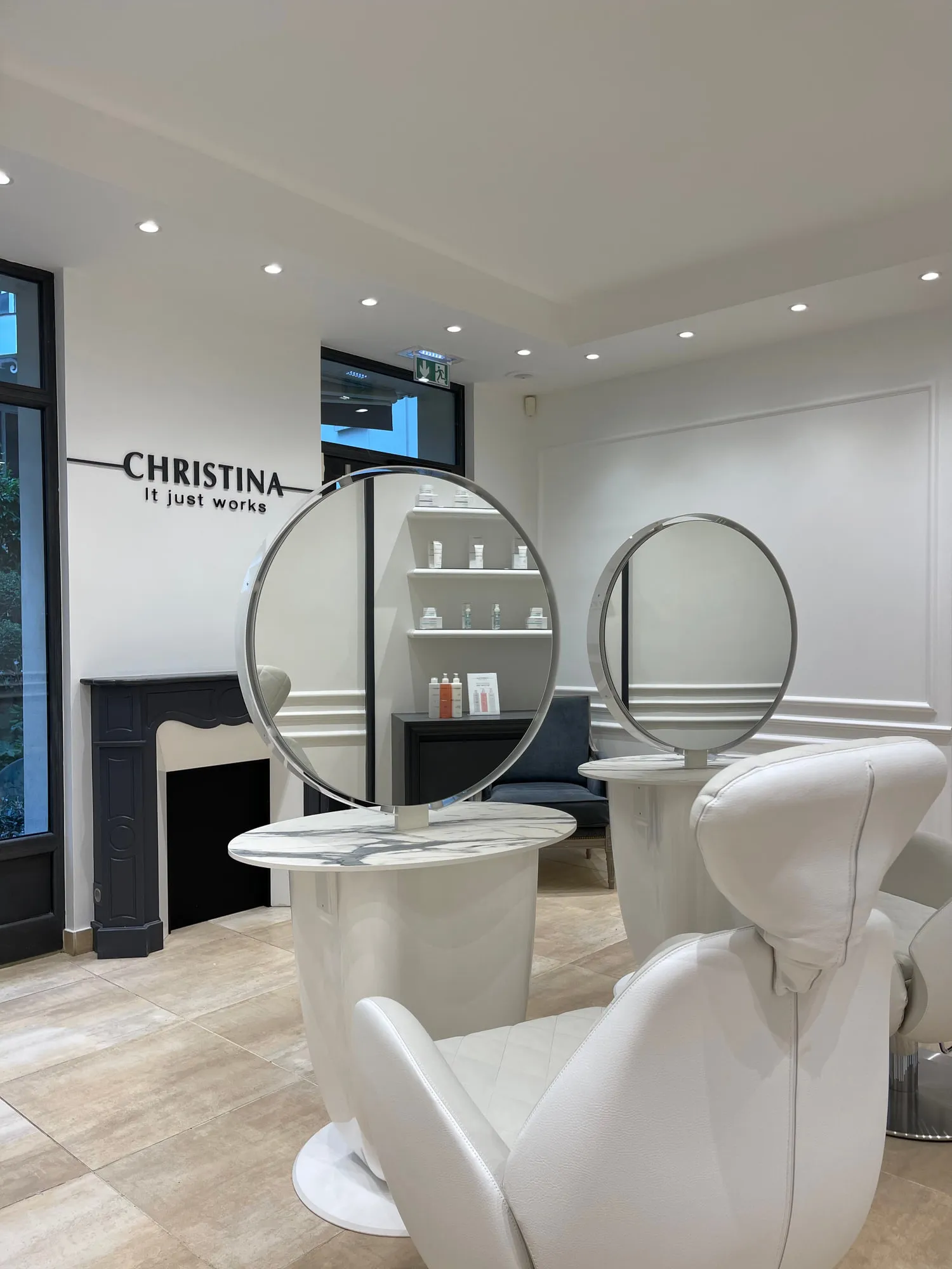 Christina Paris — round mirrors and pedestal stations against exposed Paris limestone