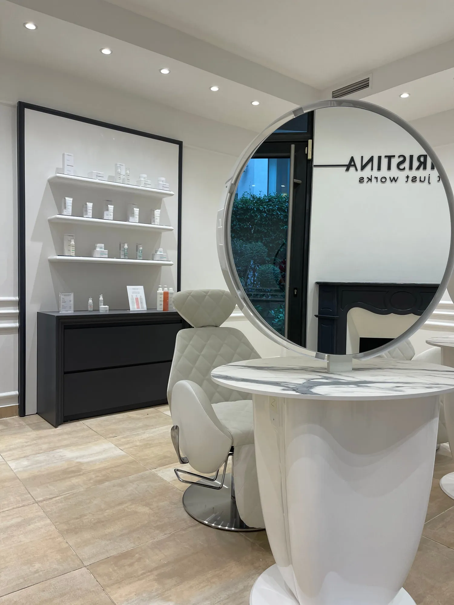Christina Paris — round mirrors and pedestal stations against exposed Paris limestone