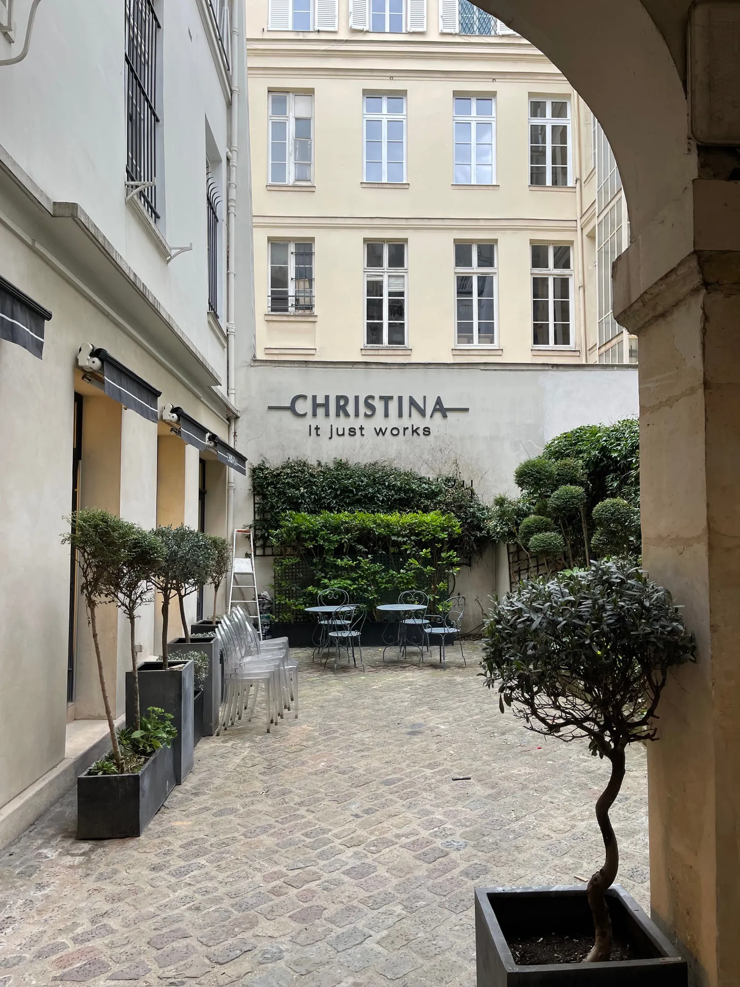 Christina Paris — round mirrors and pedestal stations against exposed Paris limestone