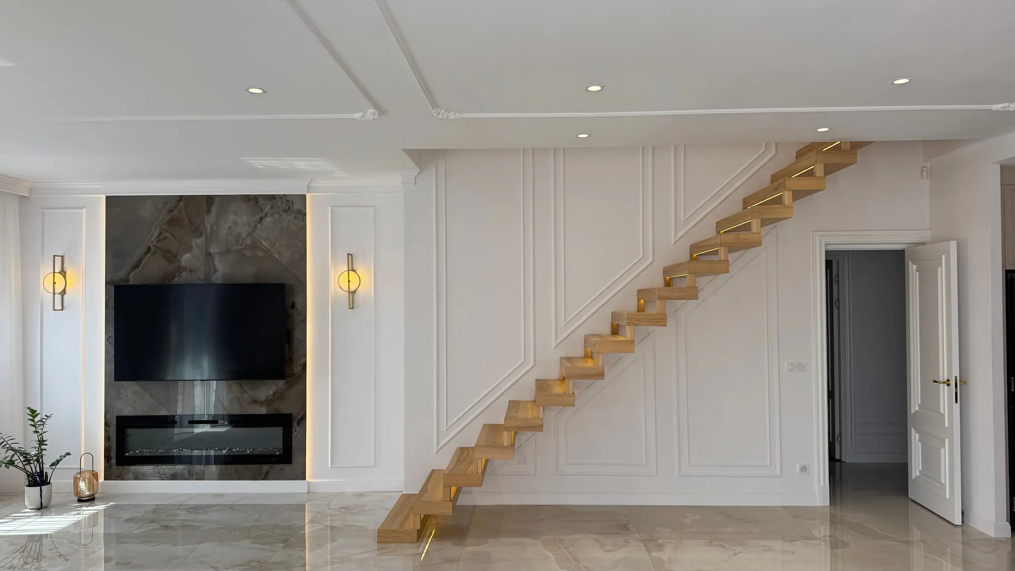 After — The stair hall: original stone flight and balustrade, rebuilt as a cantilevered oak stair