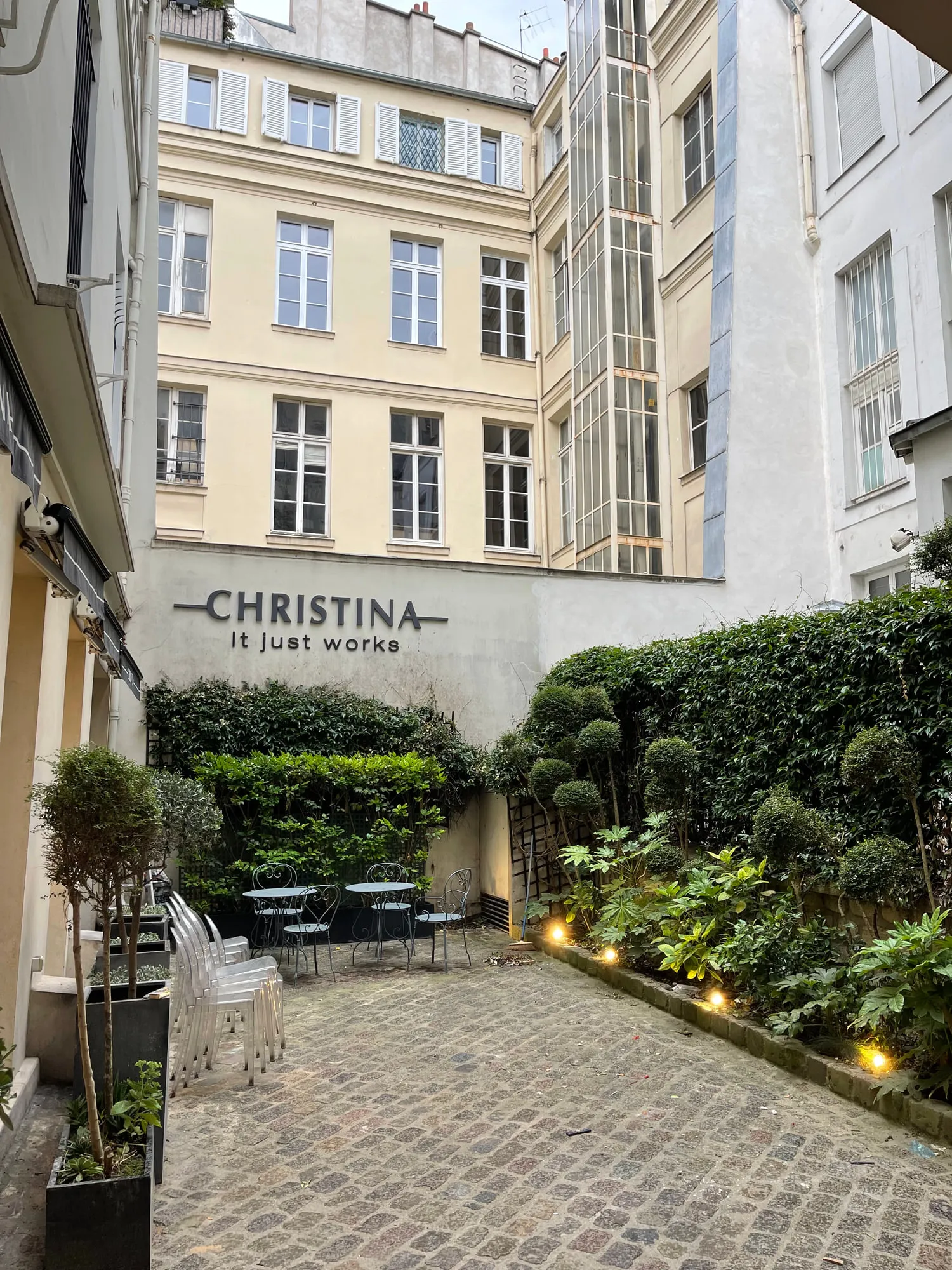 Christina Paris — round mirrors and pedestal stations against exposed Paris limestone