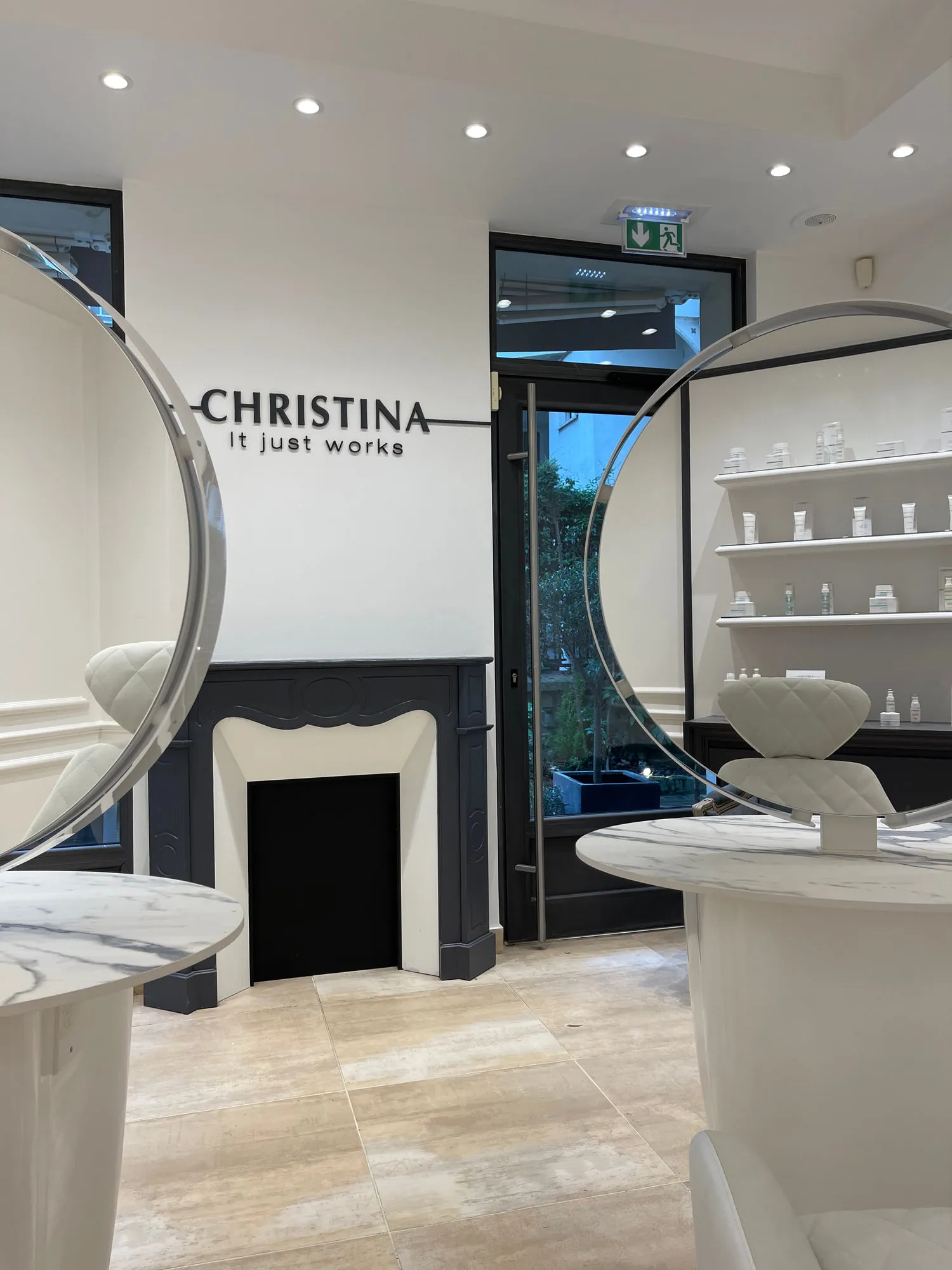 Christina Paris — round mirrors and pedestal stations against exposed Paris limestone