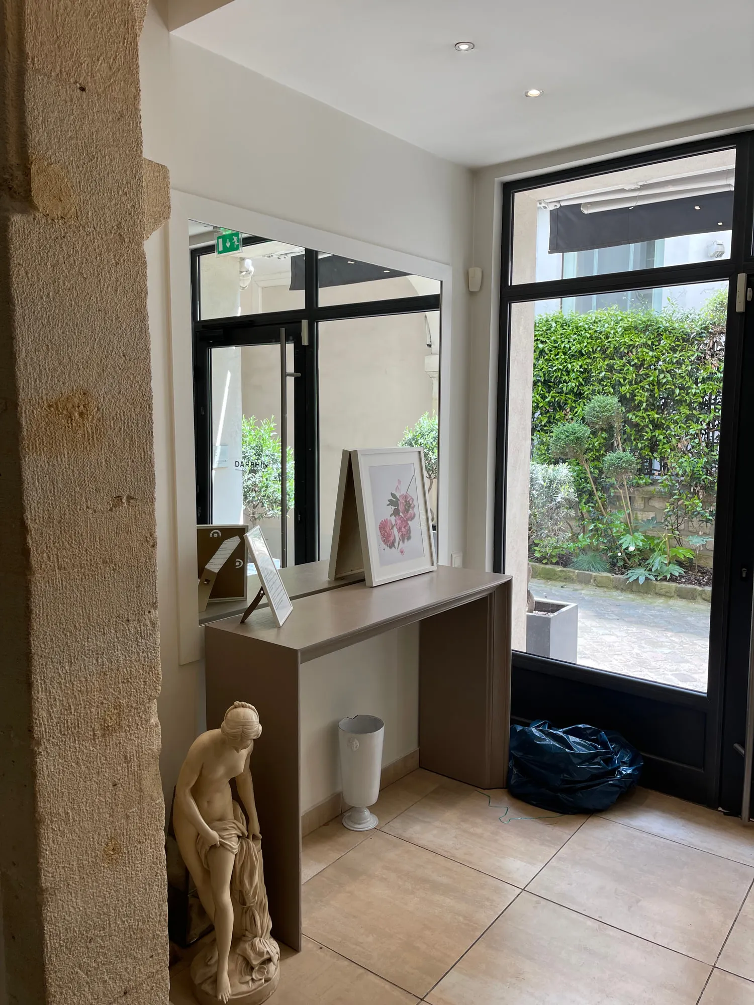 Christina Paris — round mirrors and pedestal stations against exposed Paris limestone
