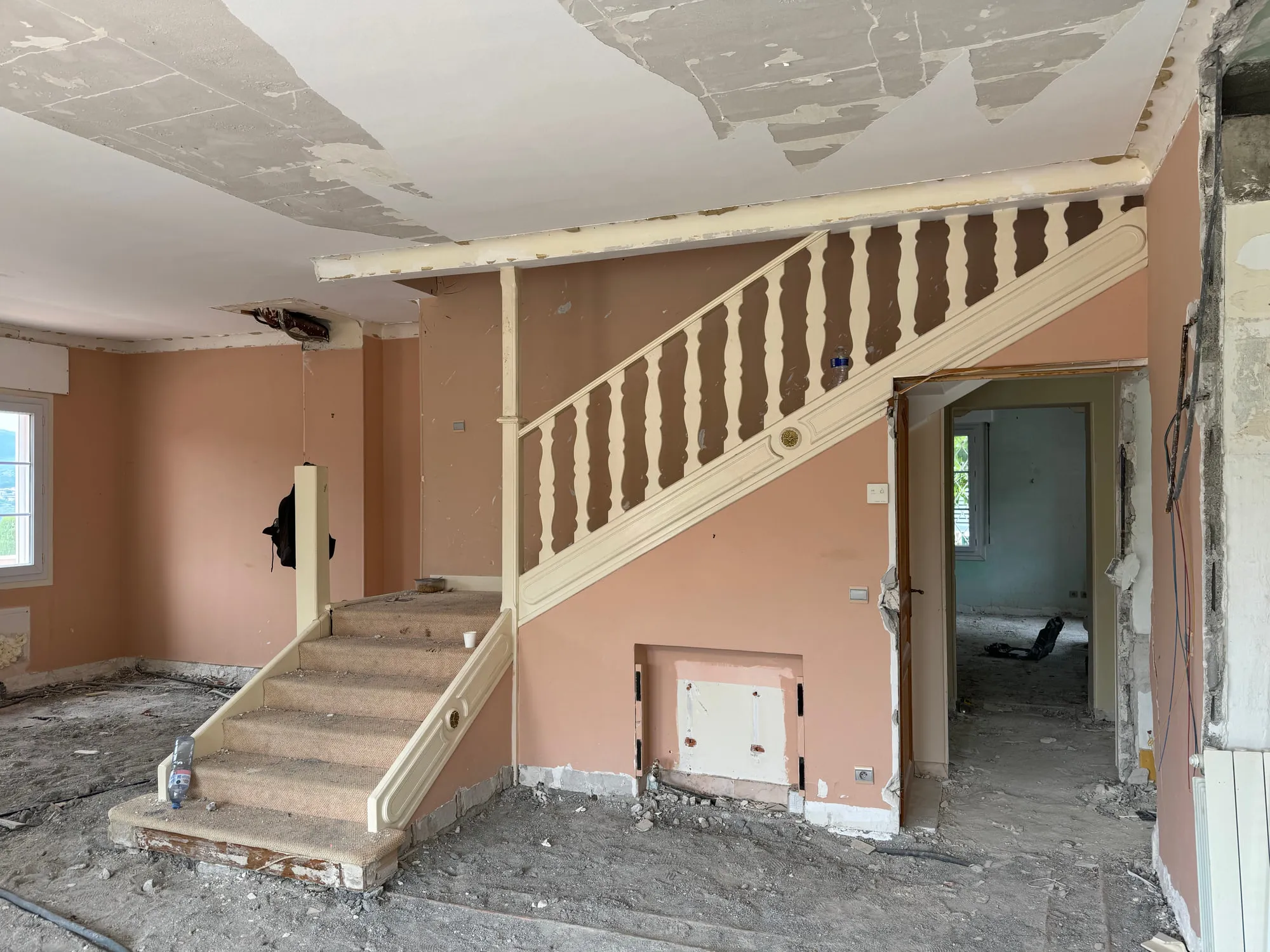 Before — The stair hall: original stone flight and balustrade, rebuilt as a cantilevered oak stair